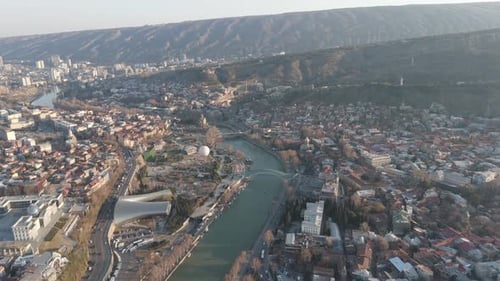 Aerial View of Tbilisi City with Kura River and Peace Bridge, Georgia
