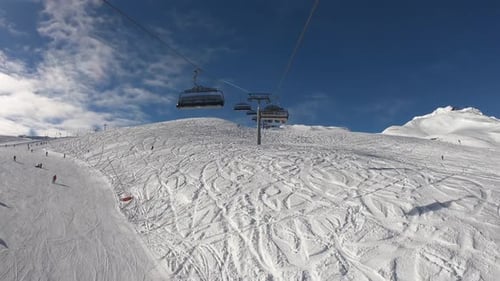 Ski Lifts and Skiers on Snowy Mountain