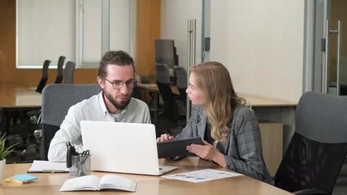 Two Business Colleagues Working in the Office