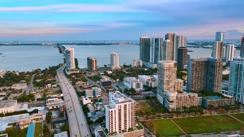 Urban architecture on the shore of the Atlantic Ocean. Aerial perspective of Miami Beach at sunset.