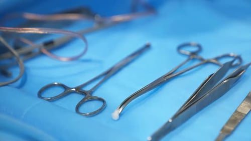 Surgical Instruments Laid Out on Blue Surface