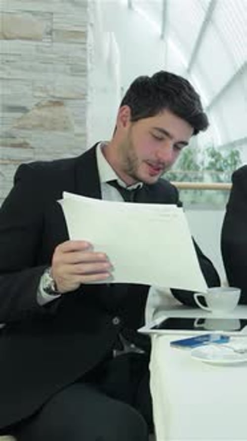 Young Professionals Reviewing Business Documents in Office