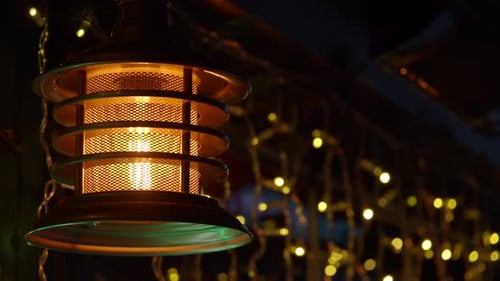 Lantern Shows Light at Night with String Lights Around It