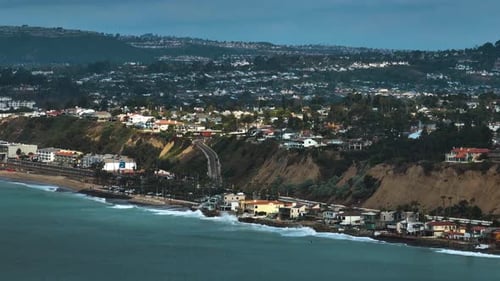 Aerial tracking shot following the coastline of San Clemente, California, USA