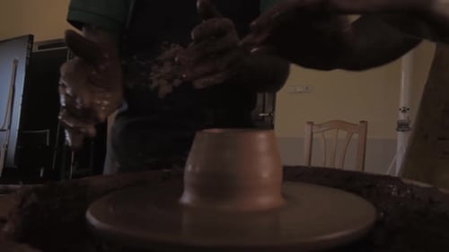 Pottery workshop, Close up of hands clay throwing on pottery wheel (adult student)