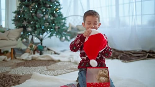 Boy Receives Santa Hat as Christmas Gift