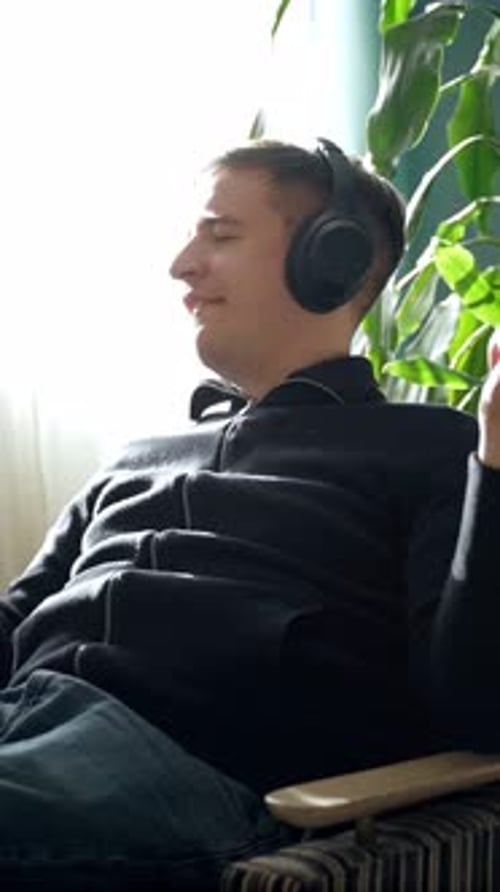 Man Wearing Headphones Listening to Music Indoors