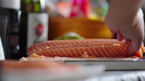 Close-Up of Sharp Knife Slicing Through Fresh Salmon with Precision