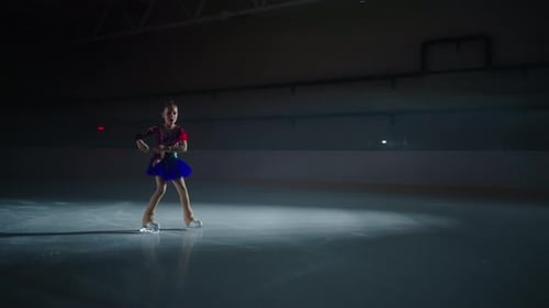Girl Figure Skater Glides and Spins on Ice Rink