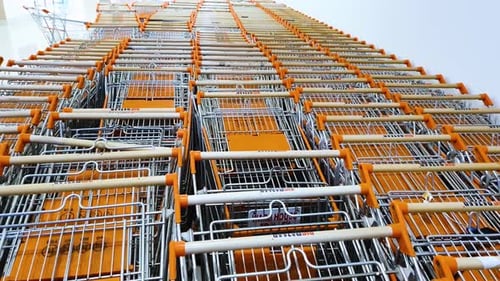 Shopping trollies lying vacant in line stack at the shopping mall due to Covid. Static.