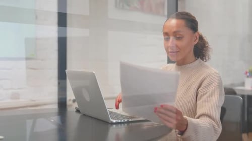 Excited Woman Celebrating Success at Office Desk