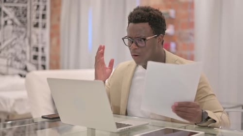 Young Adult Upset at Laptop at Home Office