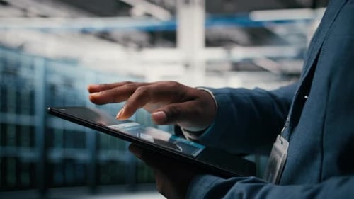 Using AI Software Tablet Close Up and Engineer in Data Center