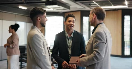 Business professionals talk together in modern office