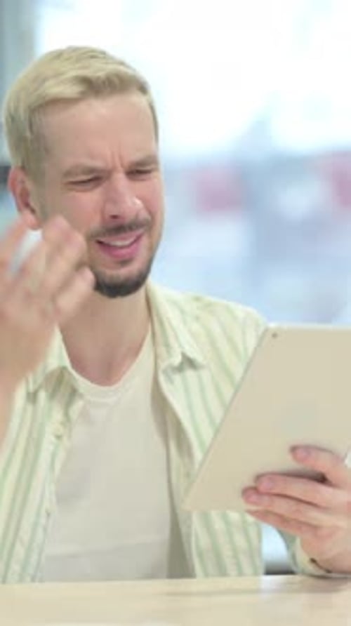 Young Adult Using Tablet Device Experiencing Problem