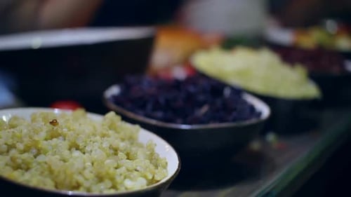 Bowls of cooked grains and salad ingredients buffet