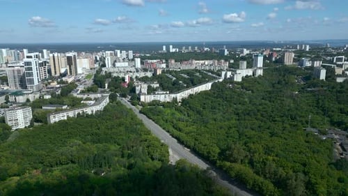 Aerial View Flying Over City and Green Forest Park Clip
