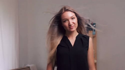 Woman with Flowing Hair Poses Indoors