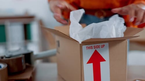 Woman Packs Merchandise into Shipping Box