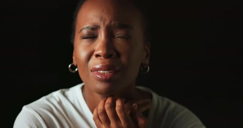 Scared, worry and prayer with black woman on dark background for fear, nervous