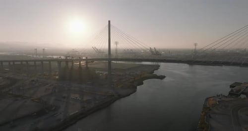 a bridge over water with a bridge and cranes