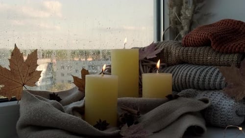 Cozy Window with Candles and Knit Sweaters