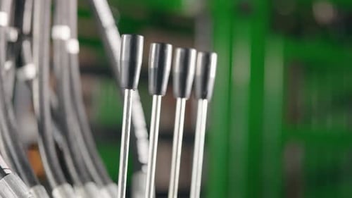 Rack focus close-up of hydraulic levers on a large agricultural in action
