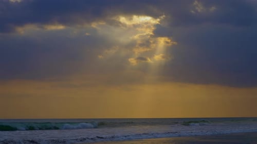 Sun Behind the Clouds Dramatic Sunset Sky Against the Background of Ocean Waves