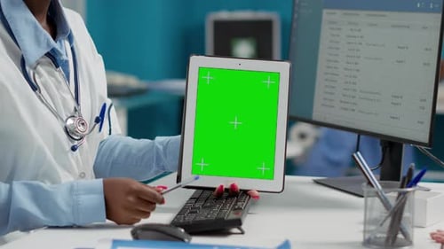 Female Doctor Holding Tablet with Greenscreen at Checkup with Paralyzed Patient