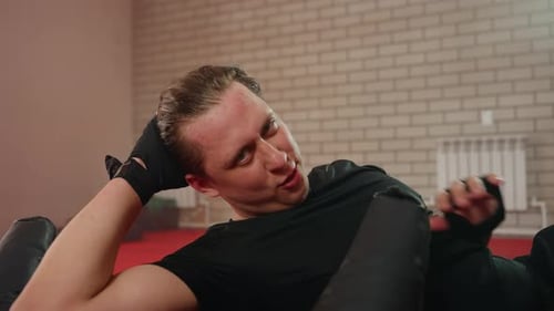 Tired Man doing Sit Ups inside Gym