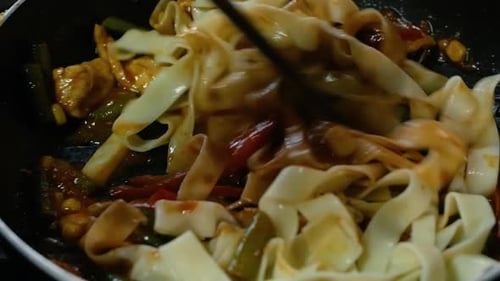 Close Up Cooking of Pasta Fettuccine with Chicken and Vegetables