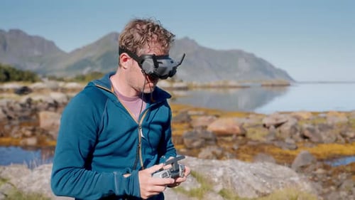Drone Operator With Headset on Rocky Coast