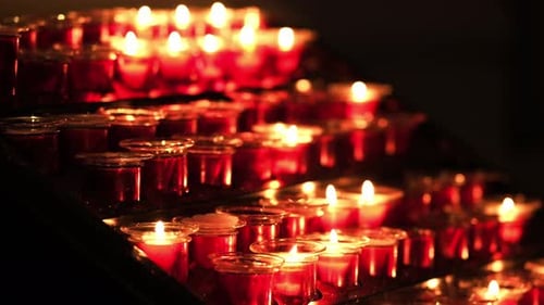 Candles In Glass Candleholders Burning In Cathedral