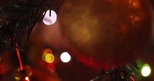 Gold Christmas Ornament Glittering on a Decorated Tree