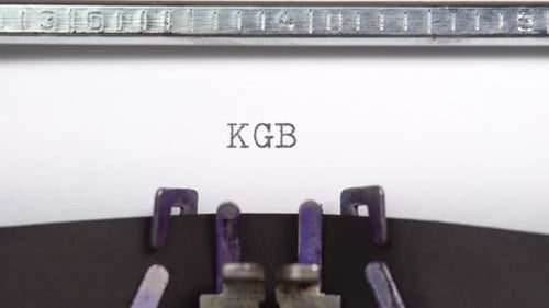 KGB word closeup being typing and centered on a sheet of paper on old vintage typewriter mechanic