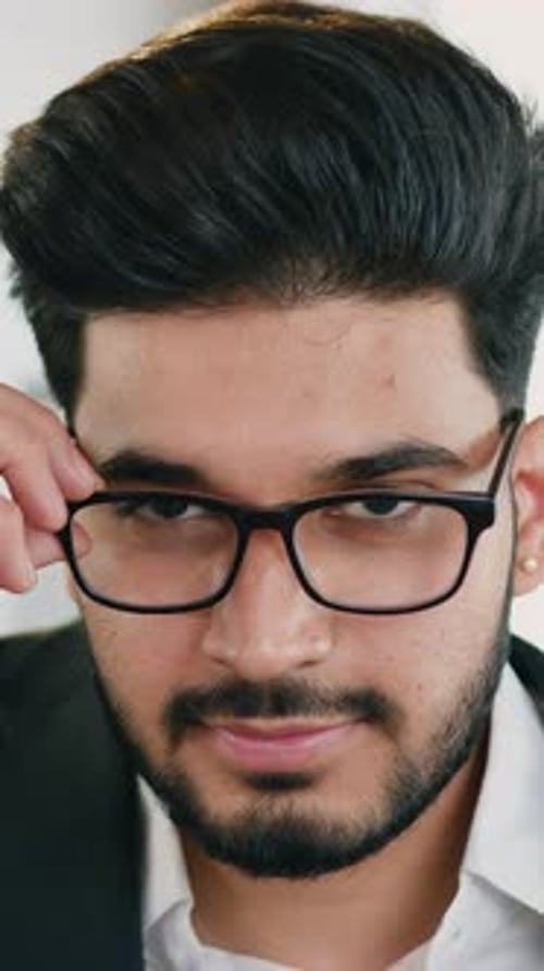Smiling Man Takes off Glasses for Close Up Portrait