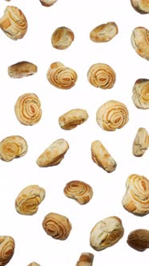 Vertikal schwebende lockige Brötchen auf weißem Grund