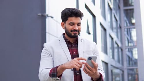Man Using Smartphone Outside Office Building
