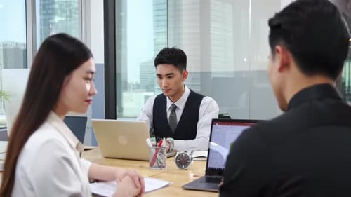 Team Meeting with Laptops in a Modern Office