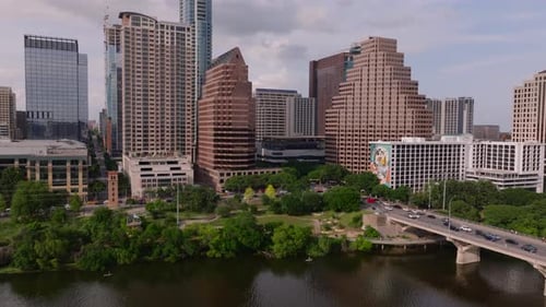 Aerial View of Austin's Skyline and Bridge Traffic Over Colorado River on a Partly Cloudy Day High