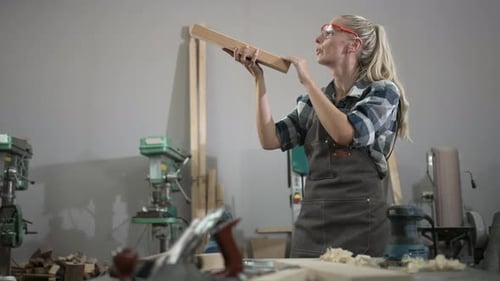 Carpenter is working at workshop.