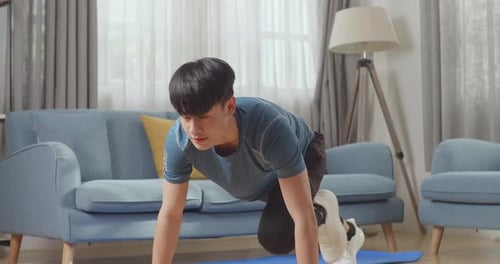 Fitness Asian Male Is Doing Mountain Climber Exercises In His Home
