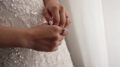 Woman in White Dress with Ring on Finger