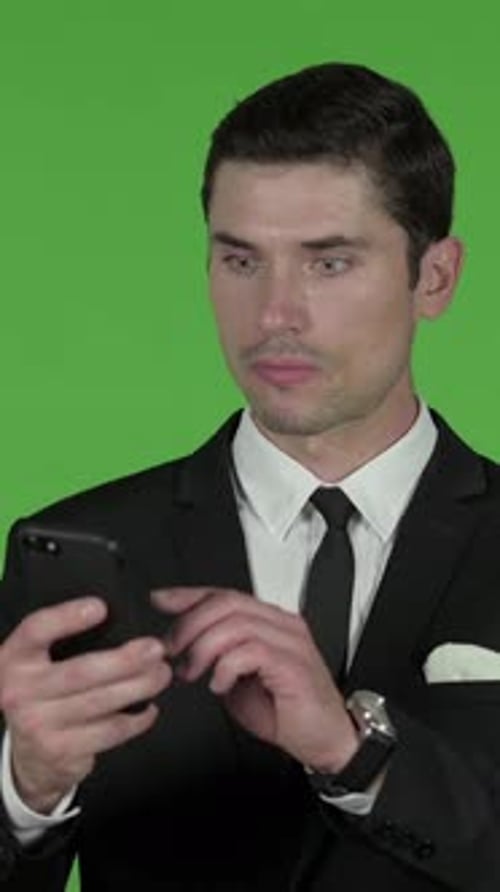 Shocked Businessman Using Smartphone, Chroma Key, vertical video