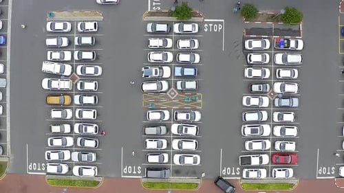 4k drone footage of cars in a parking lot