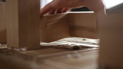 Architectural Model with Wooden Blocks Being Placed