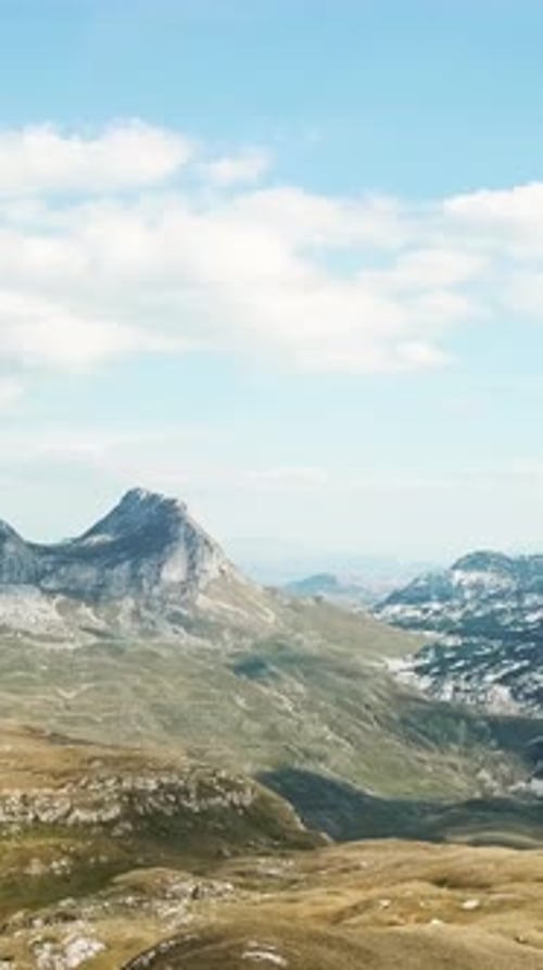 Top View of Mountain Panorama Against Blue Sky Stock Rocky Peaks of Mountains with Cover of Grass at