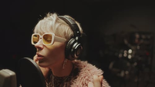 Female Singer Performing during Recording Session in Music Studio