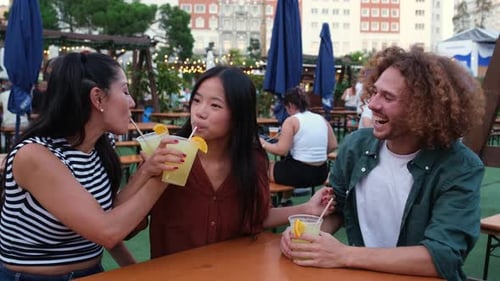 Friends sharing drinks at a rooftop bar