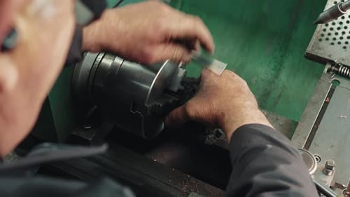 Man Operating a Metal Lathe in Workshop